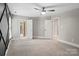 Large bedroom with neutral carpet, ceiling fan, and access to an adjoining bathroom at 121 Canterbury Xing, Fort Mill, SC 29708