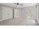 Carpeted bedroom boasts a ceiling fan, closet and bathroom access at 121 Canterbury Xing, Fort Mill, SC 29708