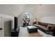 Bonus room with an exercise bike, tufted sofa, window, TV, and hardwood floors at 121 Canterbury Xing, Fort Mill, SC 29708