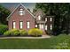 Charming two-story brick home with well-manicured lawn and mature landscaping at 121 Canterbury Xing, Fort Mill, SC 29708