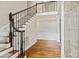 Elegant foyer featuring hardwood floors, staircase with wrought iron railing, and decorative wainscoting at 121 Canterbury Xing, Fort Mill, SC 29708