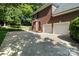 Spacious driveway leading to a two-car garage, surrounded by lush greenery at 121 Canterbury Xing, Fort Mill, SC 29708