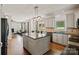 Open kitchen with stainless steel appliances, center island, and views of the living area at 121 Canterbury Xing, Fort Mill, SC 29708