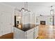 Open kitchen with stainless steel refrigerator and island with dark granite countertops at 121 Canterbury Xing, Fort Mill, SC 29708