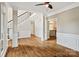 Open concept living room with hardwood floors, staircase, and access to the kitchen at 121 Canterbury Xing, Fort Mill, SC 29708