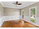 Spacious living room featuring hardwood floors, wainscoting, and a ceiling fan at 121 Canterbury Xing, Fort Mill, SC 29708