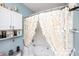 Bathroom featuring a tub-shower combo with unique petal-style shower curtains and an adjacent storage shelf at 1288 Shenandoah Cir, Rock Hill, SC 29730