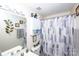 Well-lit bathroom featuring a vanity, decorative wall art, and a shower-tub combo with a patterned curtain at 1288 Shenandoah Cir, Rock Hill, SC 29730