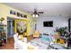 Bright and airy living room with hardwood flooring, yellow accent wall, ceiling fan and unique decor at 1288 Shenandoah Cir, Rock Hill, SC 29730