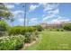 A lush backyard featuring a well-maintained lawn and colorful flower garden at 1300 Reece Rd # 206, Charlotte, NC 28209