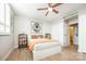 Bedroom featuring a bed with unique artwork, a ceiling fan, and wooden laminate flooring at 1300 Reece Rd # 206, Charlotte, NC 28209
