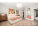 Bedroom featuring a bed with unique artwork and a walk-in closet at 1300 Reece Rd # 206, Charlotte, NC 28209