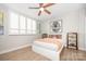 Bedroom featuring a bed with unique artwork, a ceiling fan, and wooden laminate flooring at 1300 Reece Rd # 206, Charlotte, NC 28209