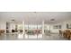 A large common area is filled with natural light, multiple seating areas, and tables at 1300 Reece Rd # 206, Charlotte, NC 28209