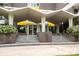 Building entrance with a covered portico, brick accents, and stairs leading to glass doors at 1300 Reece Rd # 206, Charlotte, NC 28209