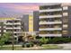 Multi-story building with brick facade, yellow accents, balconies, and landscaping at 1300 Reece Rd # 206, Charlotte, NC 28209