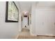 Hallway showcasing laminate wood floors, closet, white walls, and decorative artwork at 1300 Reece Rd # 206, Charlotte, NC 28209
