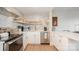 Updated kitchen featuring stainless steel appliances, floating shelves and an island with seating at 1300 Reece Rd # 206, Charlotte, NC 28209
