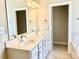 Bathroom featuring double sinks, white cabinets, and a large mirror at 1302 Devonmere Pl, Salisbury, NC 28144