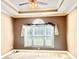 Spacious bedroom features a tray ceiling, fan, and window at 1302 Devonmere Pl, Salisbury, NC 28144