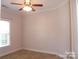 Bedroom featuring a ceiling fan, neutral carpet, and a window for natural light at 1302 Devonmere Pl, Salisbury, NC 28144