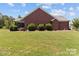 Charming brick house with manicured front lawn and lush landscaping, perfect curb appeal at 1302 Devonmere Pl, Salisbury, NC 28144