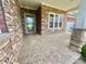 Spacious covered front porch with stone pillars and patterned concrete flooring, perfect for outdoor enjoyment at 1302 Devonmere Pl, Salisbury, NC 28144