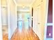 Long hallway featuring hardwood floors, archways, neutral paint, and multiple doorways, offering connectivity at 1302 Devonmere Pl, Salisbury, NC 28144