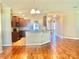 Open floor plan featuring a kitchen with wood cabinets, granite countertops, and hardwood floors at 1302 Devonmere Pl, Salisbury, NC 28144