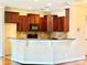 This kitchen features wood cabinets, a tile backsplash, granite countertops, and a breakfast bar at 1302 Devonmere Pl, Salisbury, NC 28144