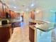 Kitchen showcasing dark wood cabinets, tile backsplash, tile floor, granite countertops, and stainless steel appliances at 1302 Devonmere Pl, Salisbury, NC 28144