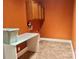 A well-lit laundry room with a work table and overhead cabinets for extra storage at 1302 Devonmere Pl, Salisbury, NC 28144