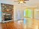 Living room featuring a ceiling fan, hardwood floors, and stone fireplace with mantel at 1302 Devonmere Pl, Salisbury, NC 28144