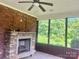 Cozy sunroom featuring a stone fireplace and large windows with serene outdoor views at 1302 Devonmere Pl, Salisbury, NC 28144
