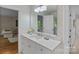 Clean bathroom with quartz countertop, white cabinets, and a large mirror at 1317 Longleaf Ct, Matthews, NC 28104