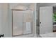 Stylish bathroom featuring a glass enclosed shower and patterned wallpaper at 1317 Longleaf Ct, Matthews, NC 28104