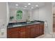 Modern bathroom with double vanity, granite countertops, and large mirror at 1317 Longleaf Ct, Matthews, NC 28104