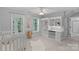 Bright Bedroom featuring a crib, built-in shelving, and windows for natural light at 1317 Longleaf Ct, Matthews, NC 28104