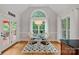 Bright dining area with a glass table, seating for four, and an arch window at 1317 Longleaf Ct, Matthews, NC 28104