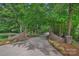 Long, paved driveway lined with trees and brick pillars leading to the house at 1317 Longleaf Ct, Matthews, NC 28104