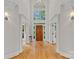 Grand foyer with soaring ceilings, hardwood floors, and a statement front door at 1317 Longleaf Ct, Matthews, NC 28104