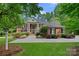 Elegant brick home with stately white columns, manicured landscaping, and a welcoming entrance at 1317 Longleaf Ct, Matthews, NC 28104