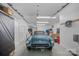 Spacious garage featuring a classic car, storage, and recreational items at 1317 Longleaf Ct, Matthews, NC 28104