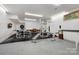 Bright home gym with full weight training equipment and large windows at 1317 Longleaf Ct, Matthews, NC 28104