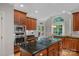 Beautiful kitchen with an island cooktop, custom cabinets and modern appliances at 1317 Longleaf Ct, Matthews, NC 28104