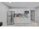 Basement kitchenette with stainless steel appliances, white cabinets, and granite countertops, offering convenience at 1317 Longleaf Ct, Matthews, NC 28104