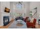 Grand living room featuring soaring windows, a cozy fireplace, and elegant decor at 1317 Longleaf Ct, Matthews, NC 28104