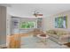 Inviting living room featuring built in shelves, hardwood floors, and a cozy seating area at 1317 Longleaf Ct, Matthews, NC 28104