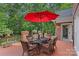 Outdoor patio with seating area, red umbrella, and brick flooring overlooking the backyard at 1317 Longleaf Ct, Matthews, NC 28104