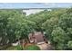 Aerial view of a sprawling estate nestled among dense trees, revealing a lake and private setting at 138 Ardmore Pl, Mooresville, NC 28117